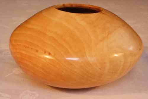 pear wood hollow form bowl with no discoloration from the buffing